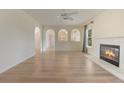 Bright living room with fireplace, new hardwood floors, arches and natural light from the windows at 16243 Wilkinson Dr, Clermont, FL 34714