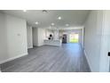 Open-concept living space featuring hardwood floors and a combined kitchen and living area at 16252 Sw 27Th Terrace Rd, Ocala, FL 34473