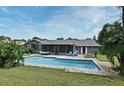 Backyard features a private pool, screened in patio, and green grass at 173 Tollgate Br, Longwood, FL 32750