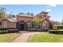 Beautiful Mediterranean-style home with well-manicured landscaping and a red tile roof at 1813 Glenbay Ct, Windermere, FL 34786