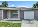 Close up of exterior, featuring a one car garage, front door, and well maintained lawn at 1816 Alexander Ave, Sanford, FL 32771
