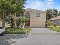 Charming two-story home features lush landscaping and a large two-car garage at 1905 Emily Blvd, Winter Haven, FL 33884