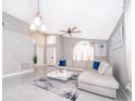 Bright living room featuring modern decor, a comfortable sectional sofa, and elegant tile flooring at 207 Langham Dr, Davenport, FL 33897