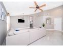 Spacious living area with neutral walls, tile flooring, and a view into the kitchen at 207 Langham Dr, Davenport, FL 33897