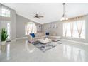 Comfortable living space with a plush sectional sofa, bright windows, and a stylish rug at 207 Langham Dr, Davenport, FL 33897