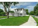 Beautiful two-story home featuring a well-manicured lawn, complementing the home's crisp, white exterior at 2300 S Brown Ave, Orlando, FL 32806