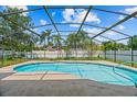 A screened-in pool with a blue and white tiled border sits under a bright blue sky at 2351 El Prado Ter, Deltona, FL 32725