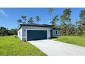 Well-maintained home boasts a spacious driveway, lush lawn, attached garage, and modern architectural design at 2500 Sw 156Th Ln Rd, Ocala, FL 34473