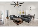 Spacious living room with high ceilings, ceiling fan, tile flooring, and comfortable seating at 2513 Hickory Oak Blvd, Orlando, FL 32817