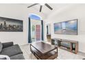 Cozy living room with tile floors, and sliding glass doors to the backyard at 2513 Hickory Oak Blvd, Orlando, FL 32817