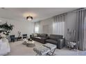 Living room featuring a textured wall, gray sofa, and decorative chandelier at 376 Willet Street Willet St, Haines City, FL 33844