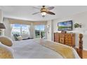 Comfortable main bedroom with a view, featuring a king-size bed and an en-suite bathroom at 4 Oceans West Blvd # 502D, Daytona Beach Shores, FL 32118