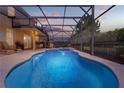 Relaxing screened-in pool and spa with an outdoor lounge area, perfect for entertaining and enjoying warm days at 5172 Oakbourne Ave, Davenport, FL 33837