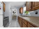 The kitchen features stainless steel appliances, wood cabinets, and a double sink at 565 S Floyd Cir, Deltona, FL 32725