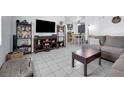 Open living room with tile flooring, stylish decor, and seamless flow to the dining area at 565 S Floyd Cir, Deltona, FL 32725