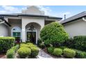 Inviting front entrance with lush landscaping and double front doors at 5740 Aloma Woods Blvd, Oviedo, FL 32765