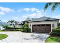 Side view of this beige home and the automatic garage door at 5740 Aloma Woods Blvd, Oviedo, FL 32765