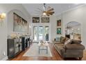 Cozy living room featuring wood floors, stylish decor, and access to outdoor pool at 5740 Aloma Woods Blvd, Oviedo, FL 32765