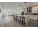 Spacious open-concept kitchen with white cabinets, stainless steel appliances, large island, and views of the living area at 63 W 10Th St, Apopka, FL 32703