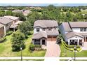 An aerial view of a two-story home with a well-manicured lawn in a lovely residential community at 6925 Trellis Vine Loop, Windermere, FL 34786