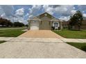 Inviting single-story home featuring a neutral stucco facade, attached garage, and manicured lawn at 7601 Fort Sumter Dr, Orlando, FL 32822