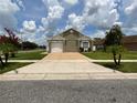 Lovely single-story home with a neutral exterior, attached garage, and spacious driveway at 7601 Fort Sumter Dr, Orlando, FL 32822