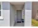 Close-up of front door with a neutral color, covered entryway, and space for decorative planters at 8618 Sw 46Th Ave, Ocala, FL 34476