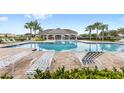 Community pool with lounge chairs and a covered patio area at 9024 Alba Ln, Kissimmee, FL 34747