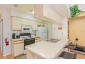 Functional kitchen with appliances and breakfast bar at 2727 N Poinciana Blvd # 134, Kissimmee, FL 34746