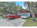 Exterior view of home and driveway featuring two parked cars under a blue sky at 10359 Smyrna Dr, Orlando, FL 32817