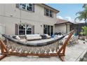 A spacious outdoor patio features an outdoor dining table, furniture, hammock, grill, and string lights at 10423 Belfry Cir, Orlando, FL 32832