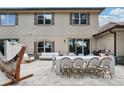 A spacious outdoor patio features an outdoor dining table, furniture, hammock, grill, and string lights at 10423 Belfry Cir, Orlando, FL 32832