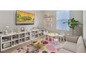 Cheerful playroom with a cozy couch, modern furniture, and playful decor at 1192 Alstonia Ln, Mount Dora, FL 32757