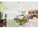 Bright living room with stylish green accents, comfortable seating, and lots of natural light at 1512 Mumbai Way, Kissimmee, FL 34747