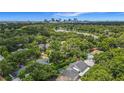 Aerial view of property showcasing landscaping, lake, and downtown skyline at 1606 Orangewood Ave, Orlando, FL 32806