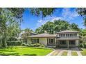 Charming single story home with mature landscaping, porte-cochere, and well-maintained lawn at 1606 Orangewood Ave, Orlando, FL 32806