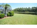 A lush green backyard with a scenic water view and mature trees at 1764 Carillon Park Dr, Oviedo, FL 32765