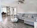 Cozy living room with a plush gray sectional sofa and stylish decor, offering a welcoming space at 1902 Sarazen Dr, Orlando, FL 32808