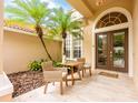 Cozy front porch with seating, landscaping, and a decorative front door at 2000 Bloomsbury Run, Lake Mary, FL 32746