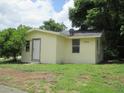 Side view of a light yellow home featuring the front door and ample windows, providing lots of light at 2112 Lee St, Orlando, FL 32805