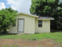 View of the side of a light yellow home, showcasing the home number next to the front door at 2112 Lee St, Orlando, FL 32805