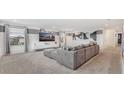 Spacious living room featuring modern gray decor, large TV, and comfortable sectional sofa at 2114 Fleming Mist Pl, Kissimmee, FL 34747
