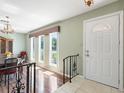 Welcoming foyer showcasing the front door and staircase with iron banister at 2151 Conifer Ave, Winter Park, FL 32792