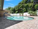 Private backyard featuring a refreshing in-ground pool and brick-paved patio area at 2151 Conifer Ave, Winter Park, FL 32792