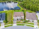Expansive home showcasing a large lot, meticulously landscaped yard, and tranquil lake views at 2275 Pearl Cider St, Orlando, FL 32824