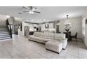 Open-concept living area featuring tile flooring, a ceiling fan, and seamless flow into the kitchen at 2275 Pearl Cider St, Orlando, FL 32824