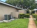 View of the side of home with lush lawn, walkway and maintained bushes at 228 Everest Pt # 108, Casselberry, FL 32707