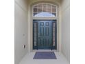 Inviting front entrance featuring a dark green door with sidelights and transom window for natural light at 2360 Brewerton Ln, Orlando, FL 32824