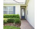 Charming front entrance with decorative glass door and brick pathway at 2362 Prairie Dunes, Clermont, FL 34711