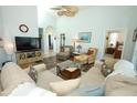 Bright living room with wood flooring, vaulted ceiling, and comfortable seating at 2362 Prairie Dunes, Clermont, FL 34711